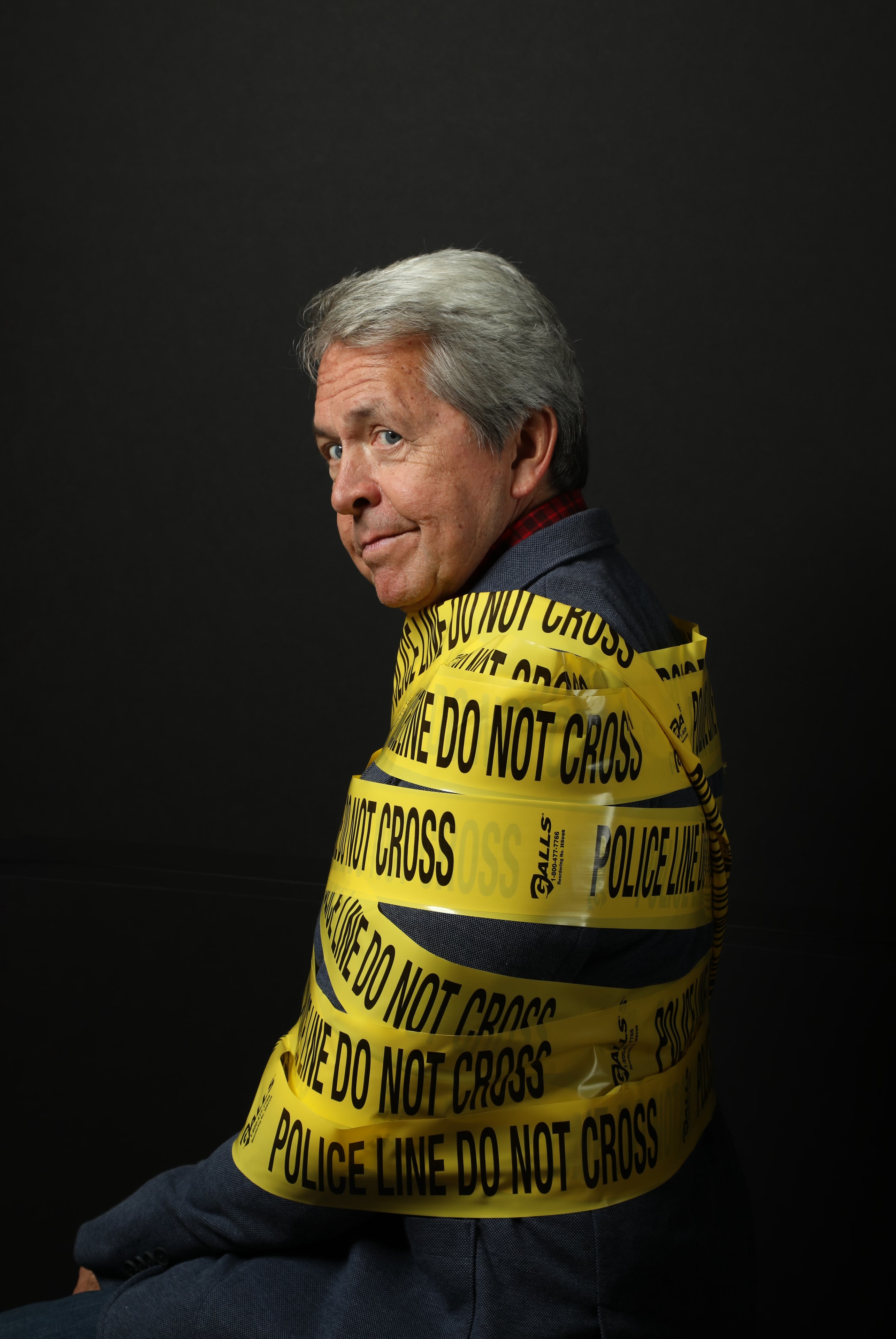 Dave Dugan wrapped in police tape